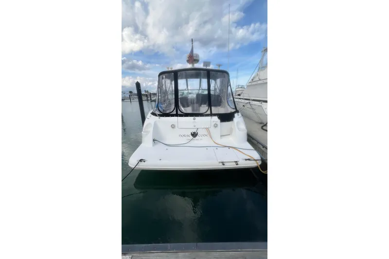 Slide: The Image of 2001 Cruisers Yachts 3572 Express docked at marina under cloudy sky. - 30