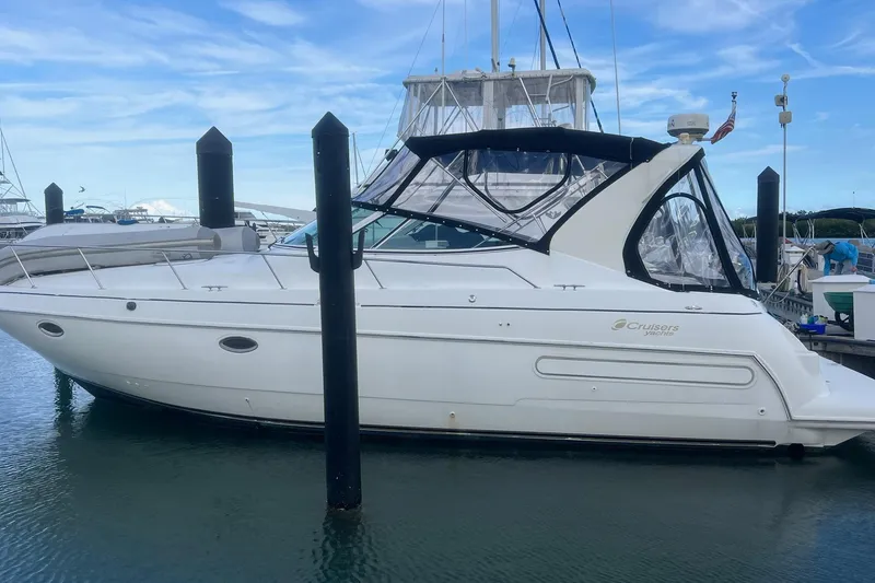 The Image of 2001 Cruisers Yachts 3572 Express docked at marina under clear blue sky. - 0