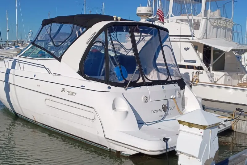 Slide: The Image of 2001 Cruisers Yachts 3572 Express docked at marina, featuring sleek design and canopy. - 1