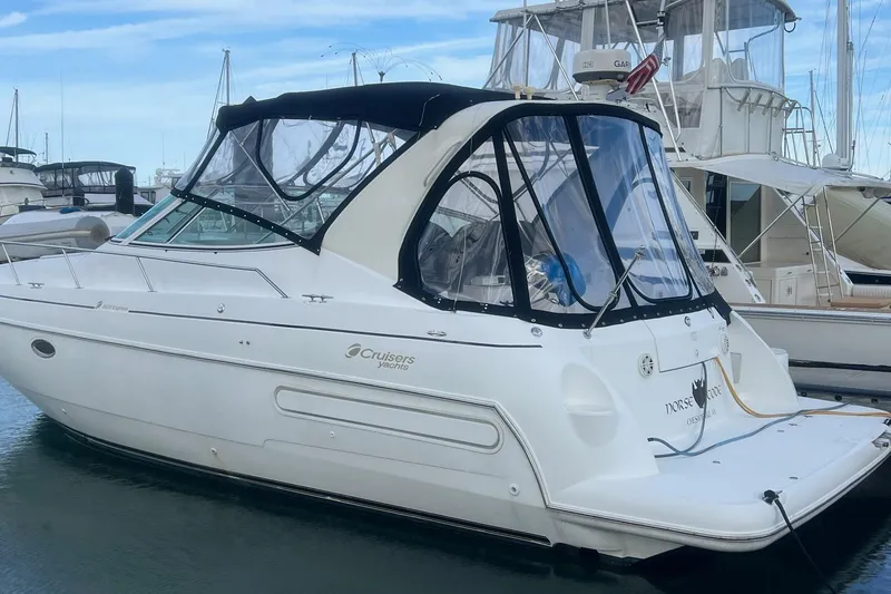 Slide: The Image of 2001 Cruisers Yachts 3572 Express docked at marina, featuring sleek design and covered cockpit. - 2