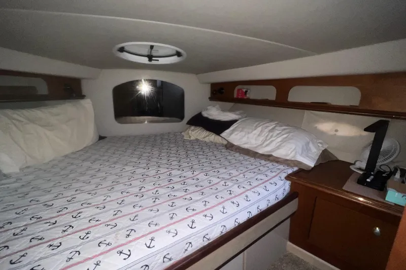 Slide: The Image of Cozy cabin interior of 2001 Cruisers Yachts 3572 Express with anchor-patterned bedding. - 21