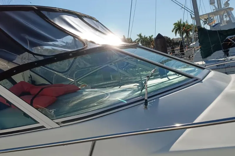 Slide: The Image of 2001 Cruisers Yachts 3572 Express boat with sunlit windshield and marina backdrop. - 28