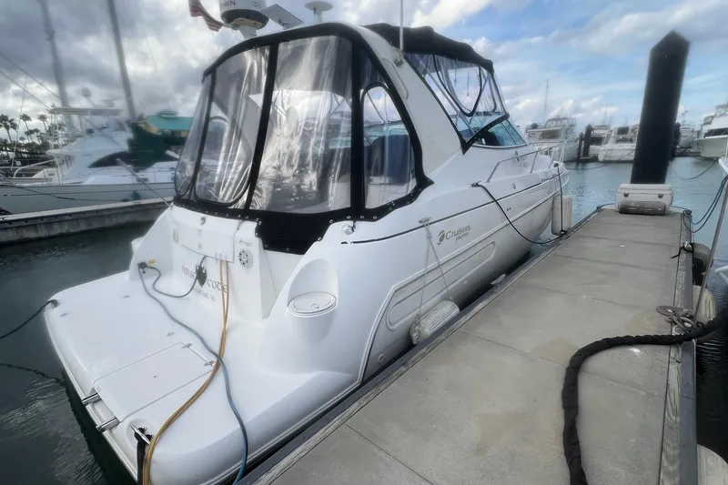 Slide: The Image of 2001 Cruisers Yachts 3572 Express docked at marina under cloudy sky. - 31