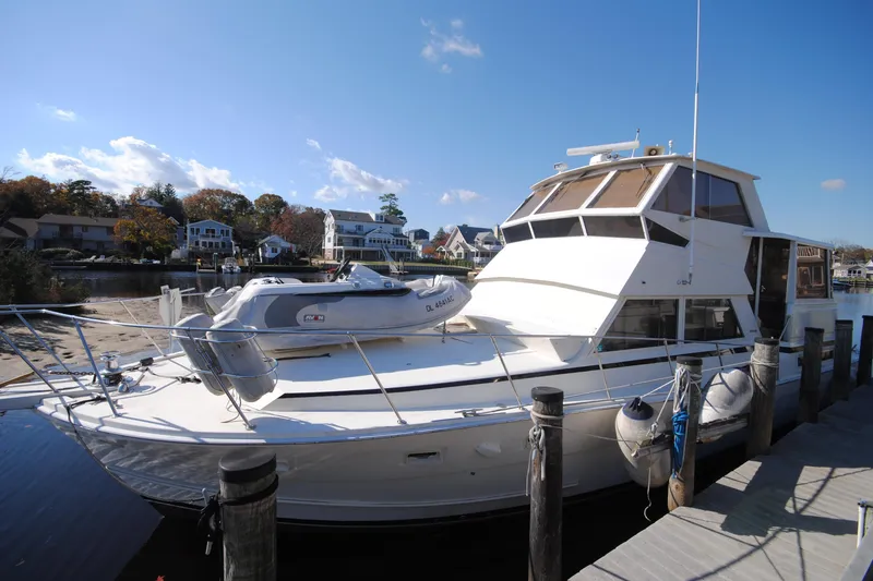 The Image of 1986 Viking 50 Motor Yacht docked, featuring sleek design and spacious deck. - 1