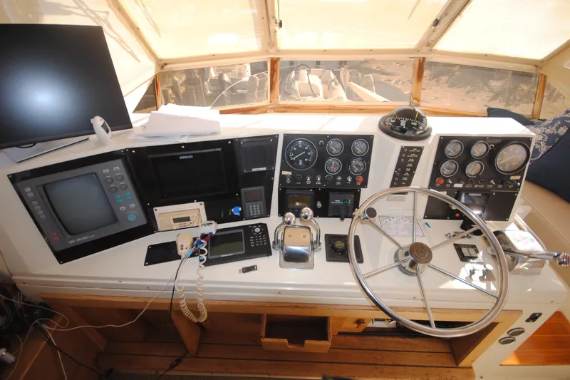Slide: The Image of 1986 Viking 50 Motor Yacht helm with navigation instruments and steering wheel. - 10