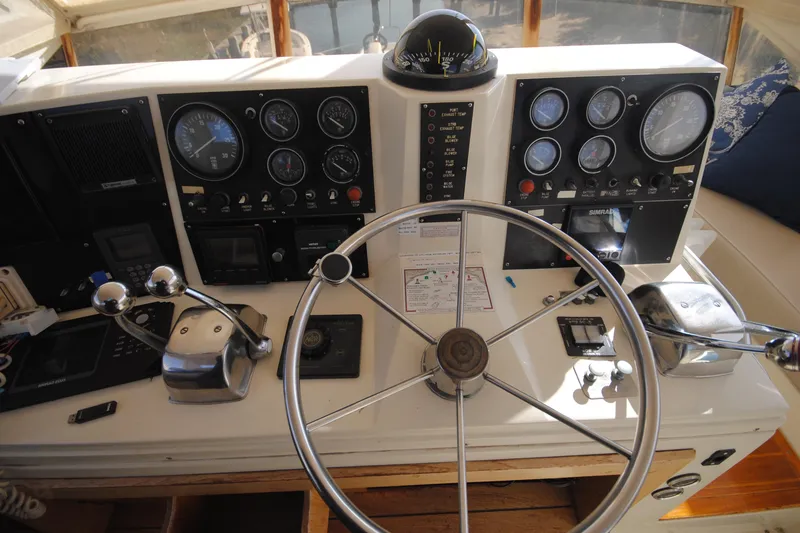 Slide: The Image of Helm of 1986 Viking 50 Motor Yacht with steering wheel and control panels. - 12
