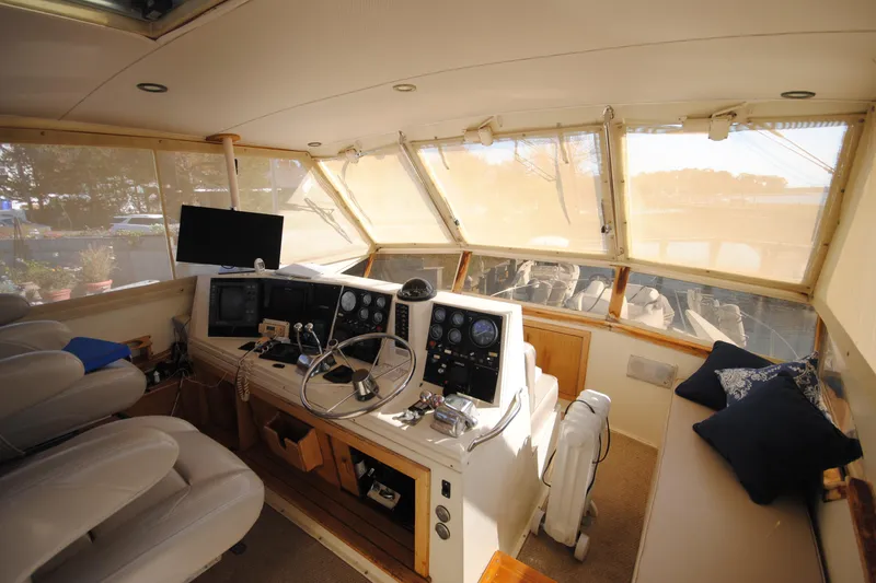 Slide: The Image of Interior helm of 1986 Viking 50 Motor Yacht with steering wheel and navigation equipment. - 13