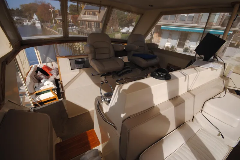Slide: The Image of Interior of 1986 Viking 50 Motor Yacht with helm and seating area. - 14