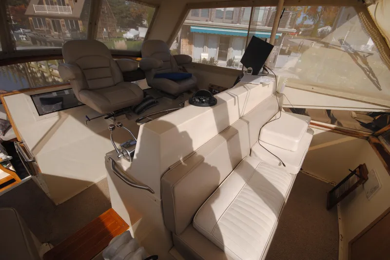 Slide: The Image of 1986 Viking 50 Motor Yacht interior with plush seating and helm station. - 15