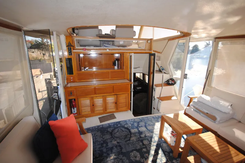 Slide: The Image of Interior of a 1986 Viking 50 Motor Yacht with wooden cabinetry and seating area. - 18