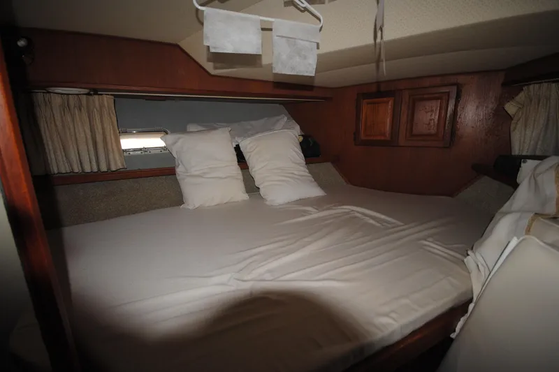 Slide: The Image of Cozy cabin interior of 1986 Viking 50 Motor Yacht with bed and pillows. - 20