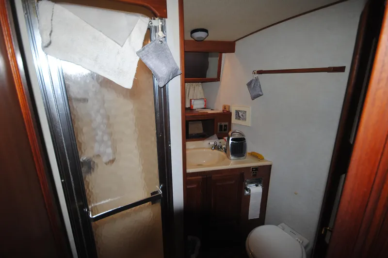 Slide: The Image of Bathroom interior of 1986 Viking 50 Motor Yacht with shower, sink, and toilet. - 22