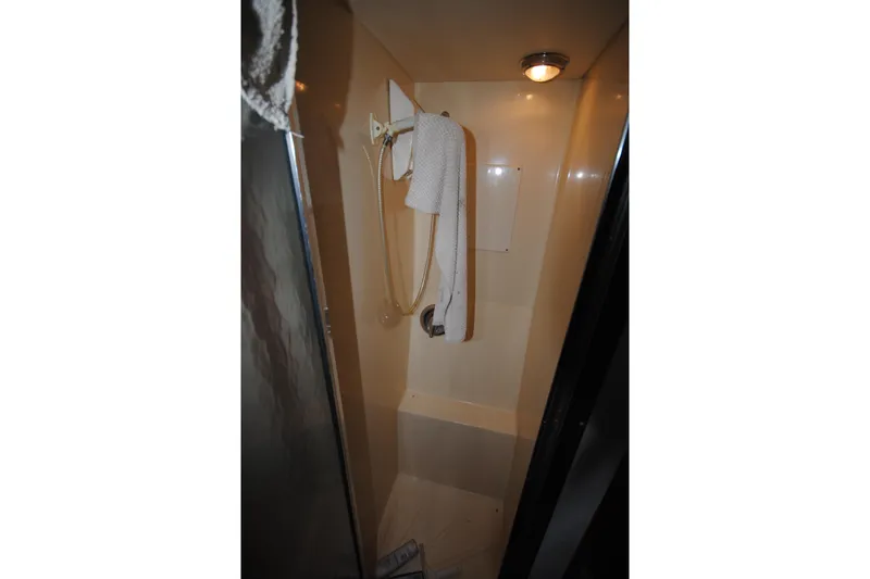 Slide: The Image of Shower area in 1986 Viking 50 Motor Yacht with towel and lighting. - 24