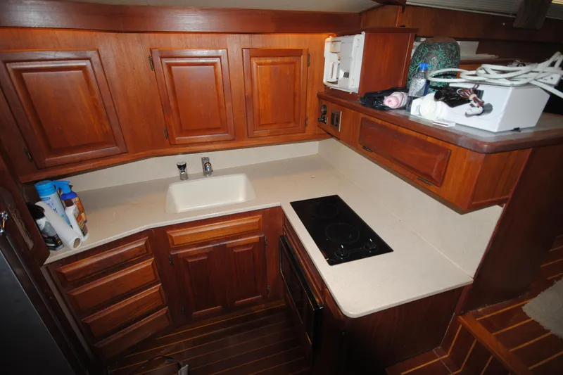 Slide: The Image of 1986 Viking 50 Motor Yacht kitchen with wooden cabinets and modern appliances. - 26