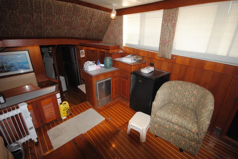 Slide: The Image of Interior of 1986 Viking 50 Motor Yacht with wood paneling and cozy seating area. - 32