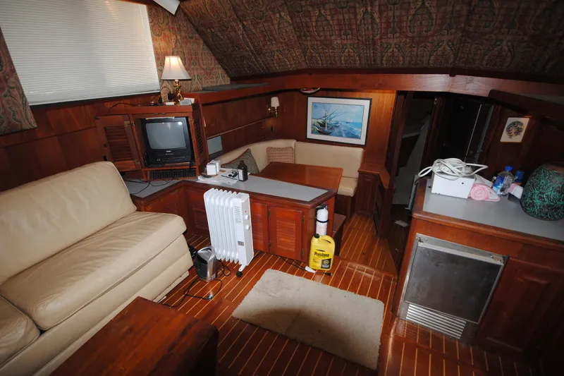 Slide: The Image of Interior of 1986 Viking 50 Motor Yacht with cozy seating and vintage decor. - 33