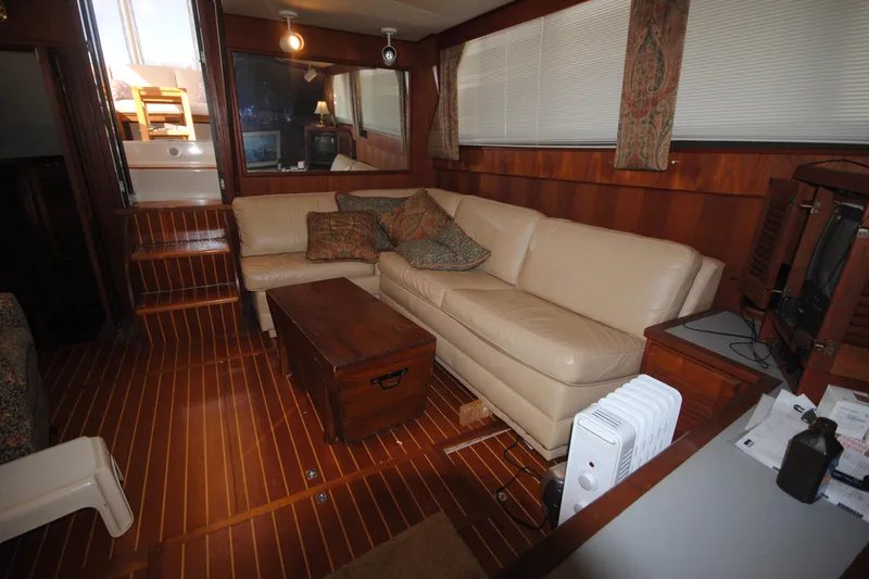 Slide: The Image of Interior of 1986 Viking 50 Motor Yacht with beige sofa and wooden decor. - 34
