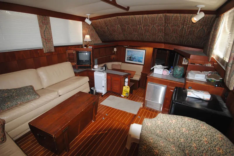 Slide: The Image of Interior of 1986 Viking 50 Motor Yacht with cozy seating and vintage decor. - 36