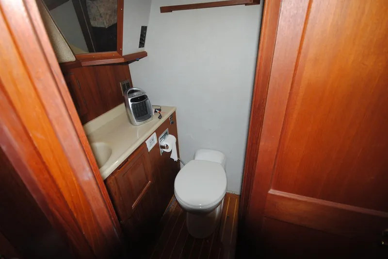 Slide: The Image of Bathroom interior of 1986 Viking 50 Motor Yacht with wooden cabinetry and compact design. - 40