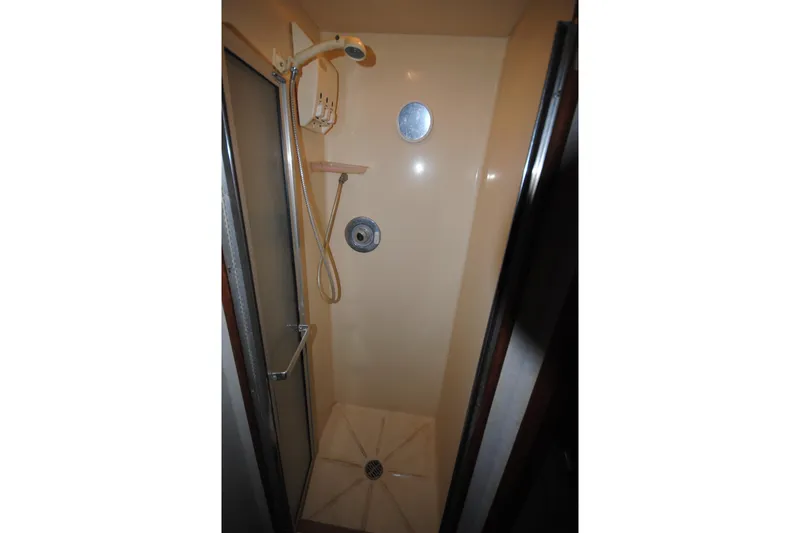 Slide: The Image of Shower area in 1986 Viking 50 Motor Yacht, featuring compact design and handheld showerhead. - 41