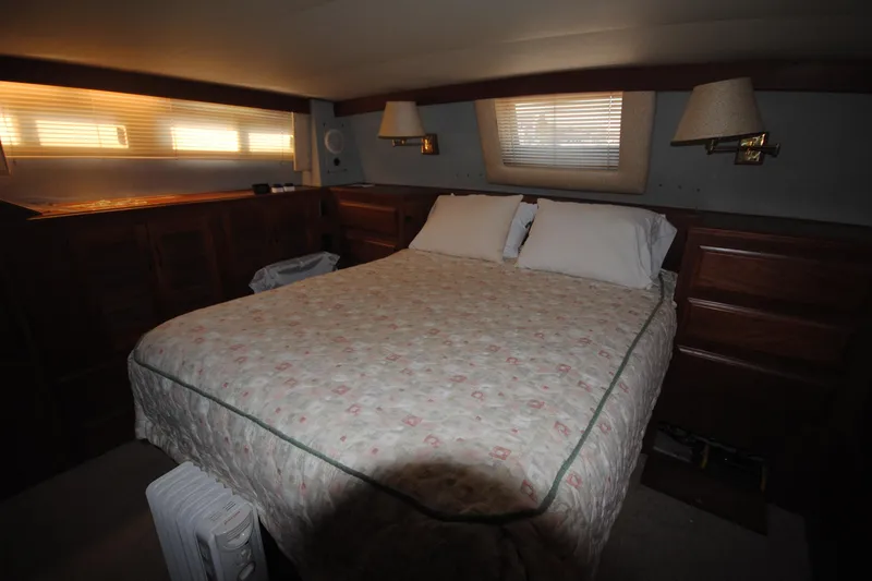 Slide: The Image of Cozy bedroom in 1986 Viking 50 Motor Yacht with double bed and wooden cabinetry. - 42