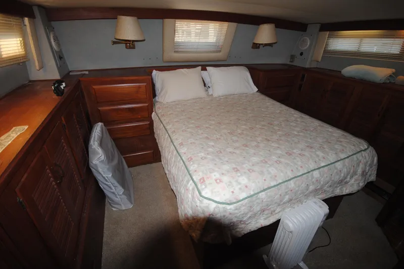 Slide: The Image of Cozy bedroom interior of 1986 Viking 50 Motor Yacht with wood cabinetry and double bed. - 43