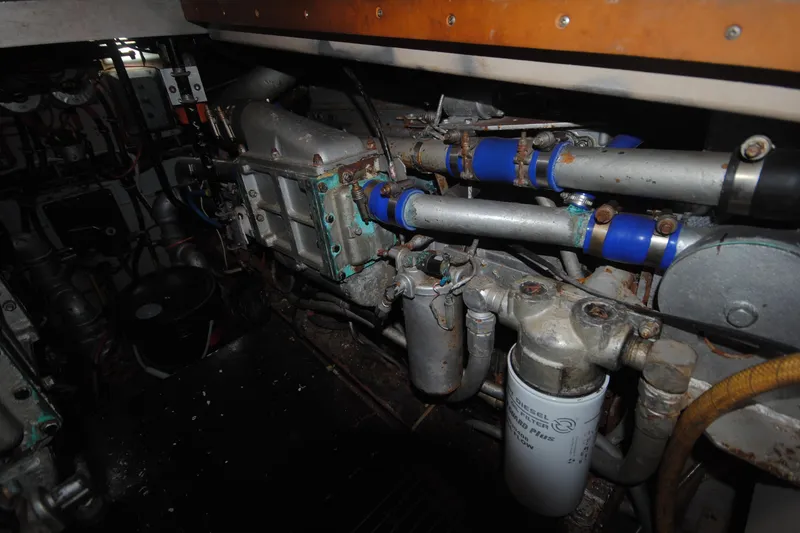 Slide: The Image of Engine room of a 1986 Viking 50 Motor Yacht, showcasing mechanical components and piping. - 50