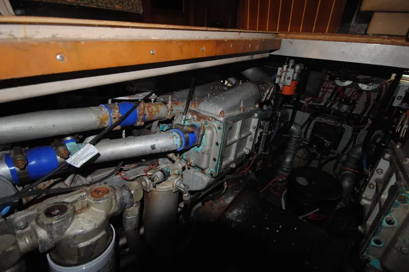Slide: The Image of Engine room of a 1986 Viking 50 Motor Yacht, showcasing mechanical components and piping. - 52