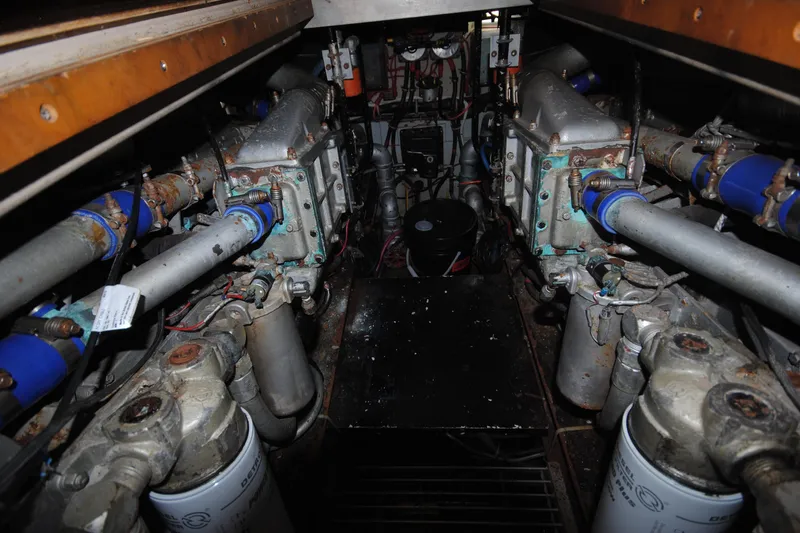 Slide: The Image of Engine room of 1986 Viking 50 Motor Yacht, showcasing mechanical components and piping. - 53