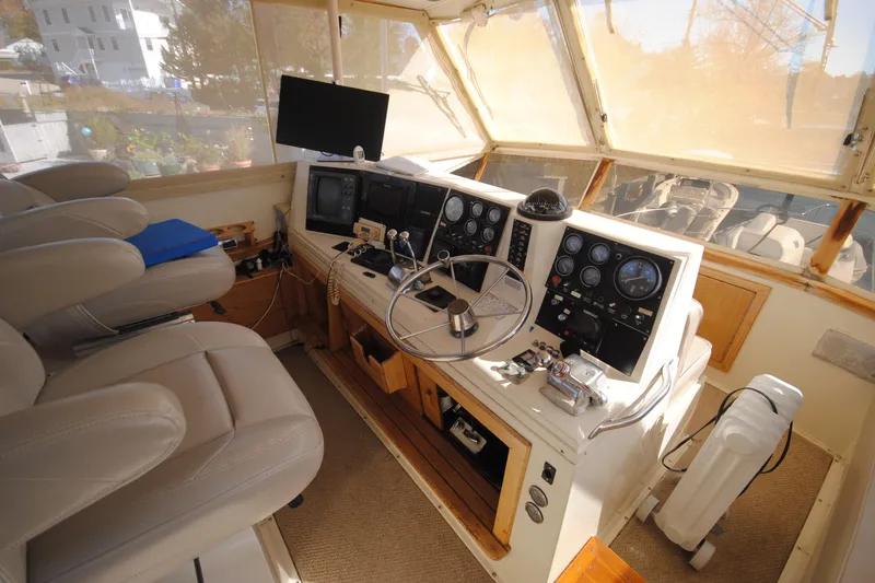 Slide: The Image of Interior helm of 1986 Viking 50 Motor Yacht with steering wheel and navigation instruments. - 8