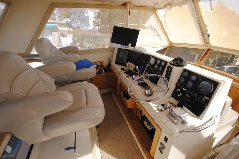 Slide: The Image of Interior helm of 1986 Viking 50 Motor Yacht with steering wheel and control panels. - 9