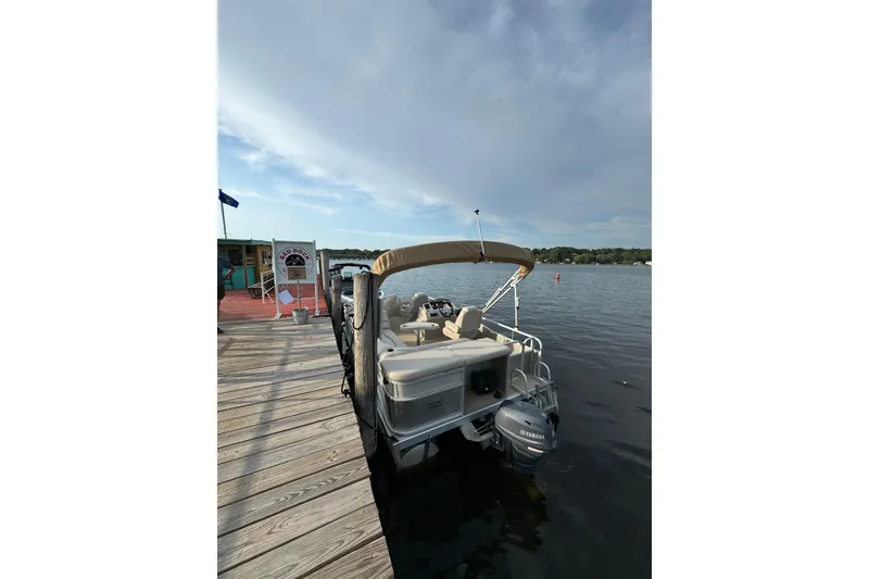 Slide: The Image of 2015 Bennington 17S pontoon boat with Yamaha motor on trailer. - 2