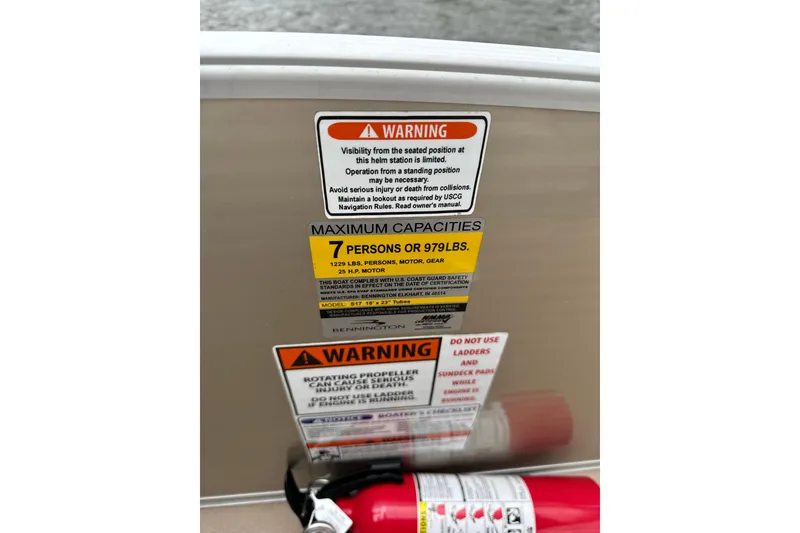 Slide: The Image of Warning labels on a 2015 Bennington 175 boat, indicating capacity and safety instructions. - 7