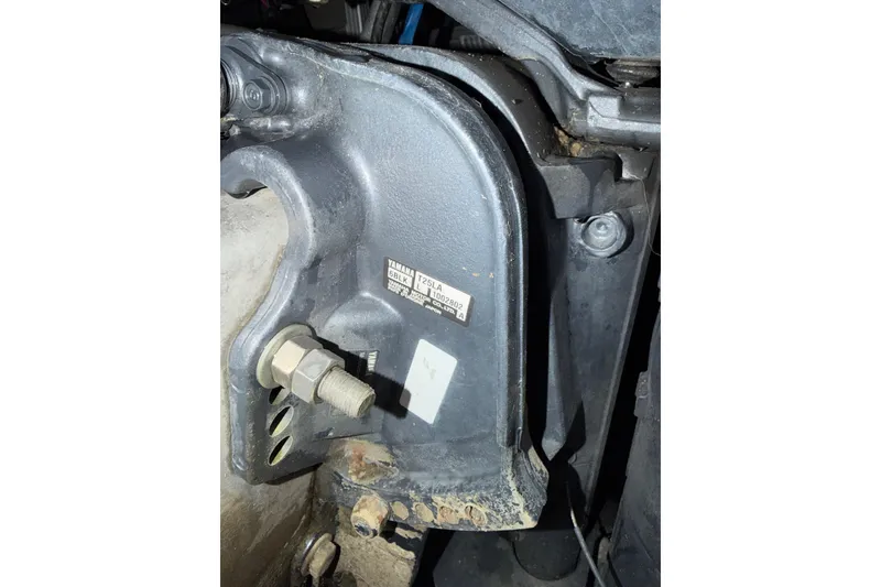 Slide: The Image of Close-up of a 2015 Bennington 175 engine component with visible bolts and label. - 8