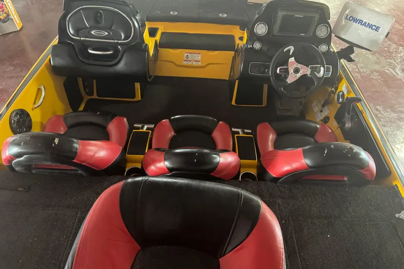 Slide: The Image of 2015 Nitro Z-9 DC boat interior with red and black seats, steering console, and Lowrance equipment. - 4