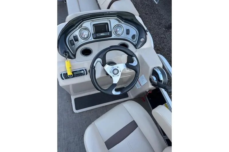 Slide: The Image of 2018 Sun Tracker Party Barge 22 XP3 steering console with gauges and controls. - 6