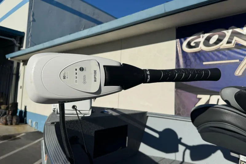 Slide: The Image of 2024 Lund 1400 Fury SS boat with Riptide trolling motor in a sunny outdoor setting. - 4