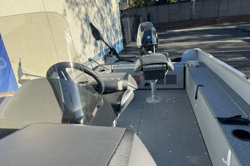 Slide: The Image of 2024 Lund 1400 Fury SS boat interior with steering wheel and seating. - 6