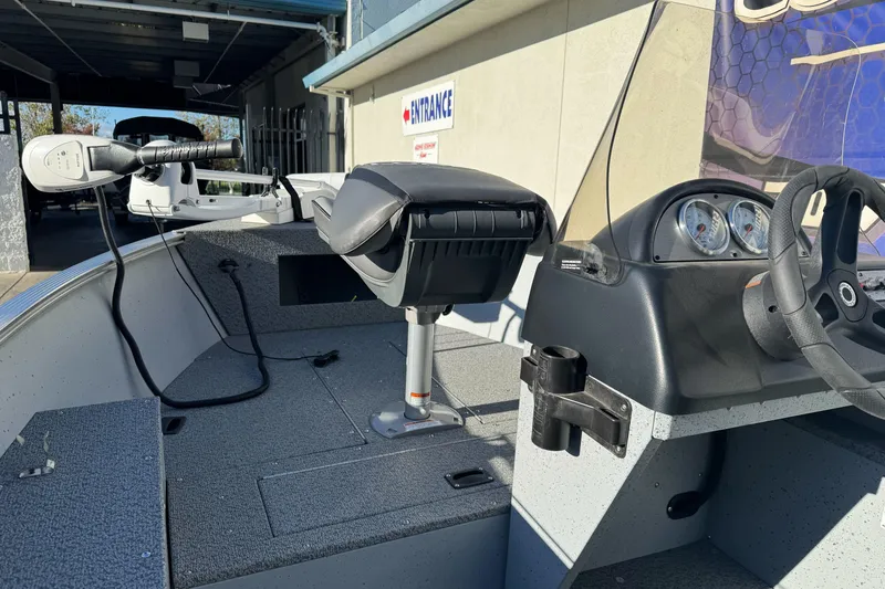 Slide: The Image of 2024 Lund 1400 Fury SS boat interior with steering console and seating. - 7