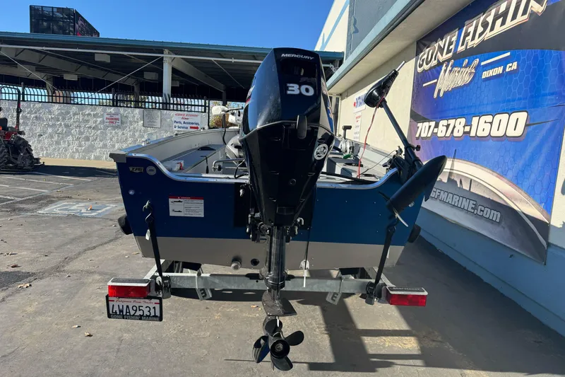 Slide: The Image of 2024 Lund 1400 Fury SS boat with Mercury 30 engine at dealership. - 8