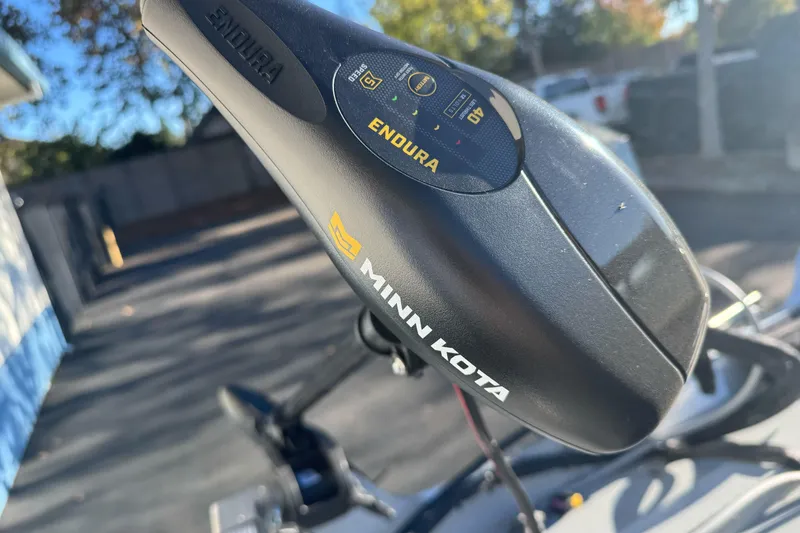 Slide: The Image of Minn Kota Endura motor on 2024 Lund 1400 Fury SS boat, outdoor setting. - 9