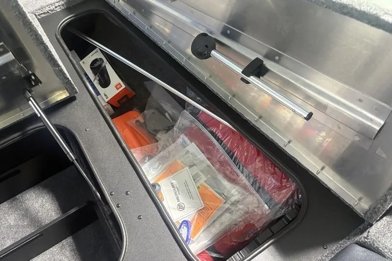 Slide: The Image of 2026 Tracker Pro Team 175 boat interior with gray carpeted deck and seating area. - 13