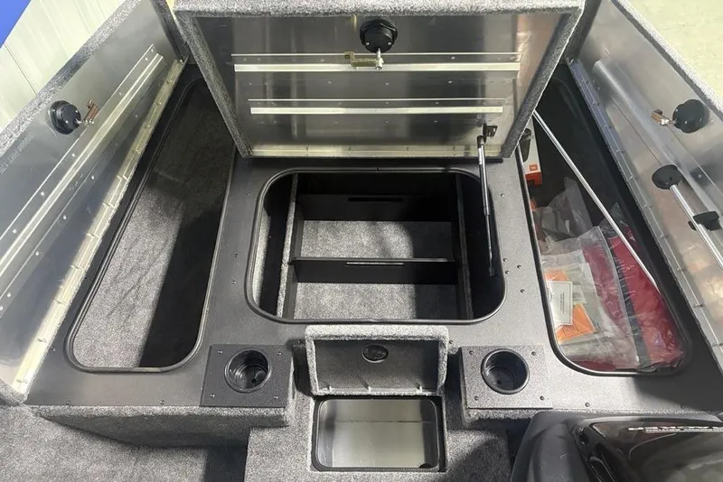Slide: The Image of Open storage compartment in 2026 Tracker Pro Team 175 boat with various items inside. - 17