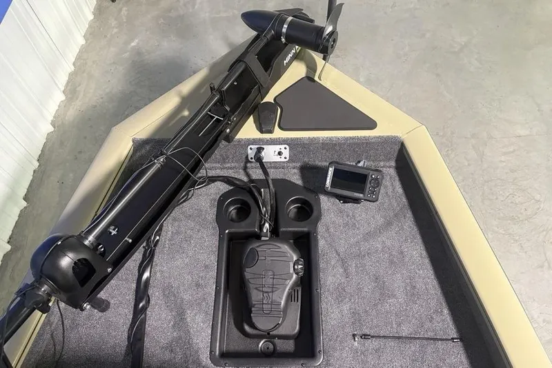 Slide: The Image of Livewell compartment in 2026 Tracker Pro Team 175 boat, featuring a clean, carpeted interior. - 19