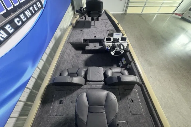 Slide: The Image of 2026 Tracker Pro Team 175 boat interior with steering console and seating. - 29