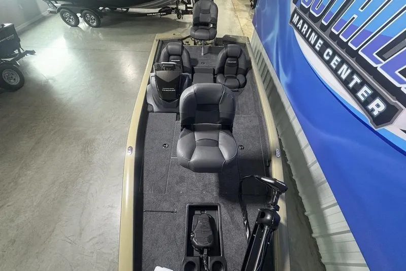 Slide: The Image of 2026 Tracker Pro Team 175 boat interior with seating and equipment in a showroom. - 31