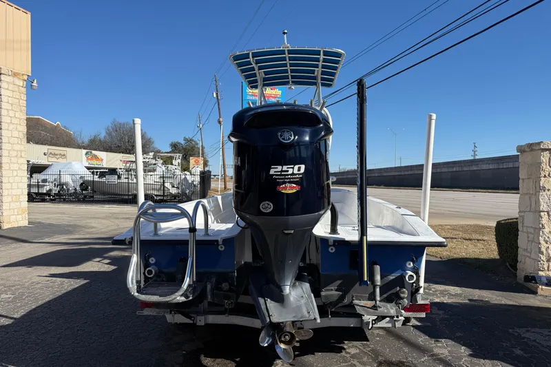 Slide: The Image of 2018 Shallow Sport 24 Modified V boat with Yamaha 250 outboard motor, parked outdoors. - 16