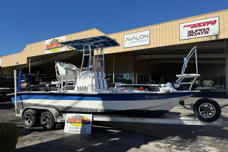 Slide: The Image of 2018 Shallow Sport 24 Modified V boat on trailer outside dealership. - 20