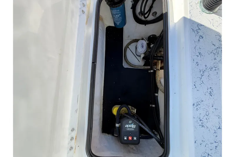 Slide: The Image of 2018 Shallow Sport 24 Modified V boat compartment with equipment and wiring. - 24