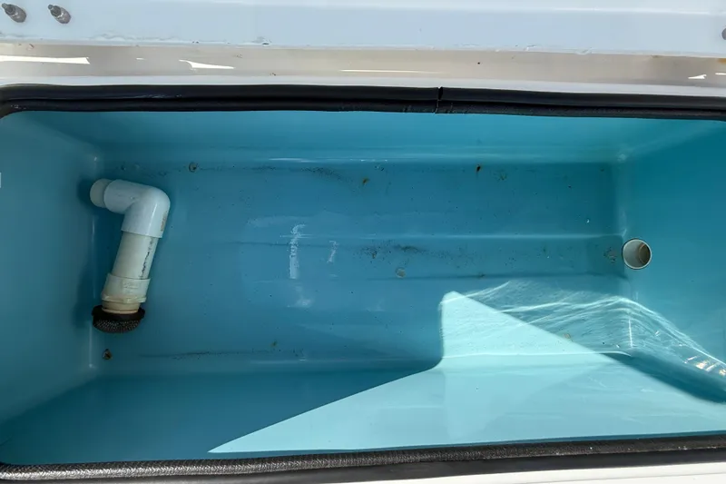 Slide: The Image of Empty livewell in 2018 Shallow Sport 24 Modified V boat, featuring plumbing components. - 25